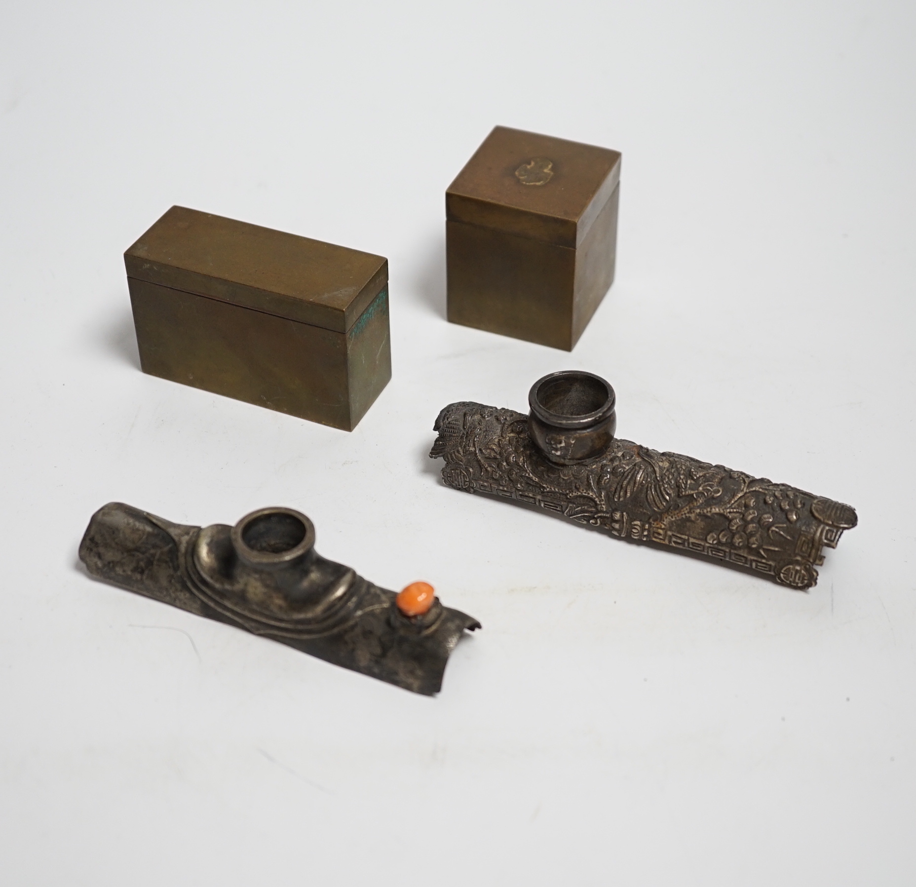 Two white metal opium pipe heads and two opium boxes (mid 20th century)